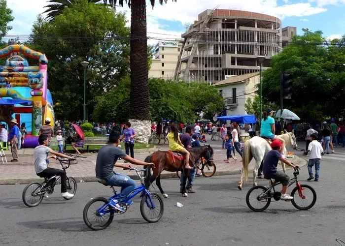 People riding bikes and horses on car-free streets